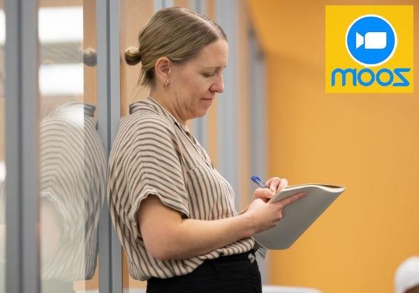 Woman writing on paper standing up 