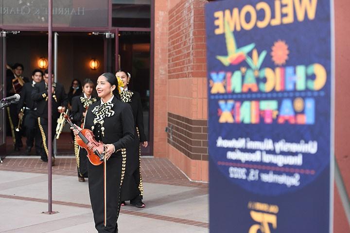 Musicians enter stage to perform on instruments