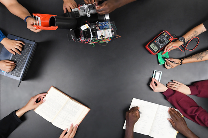 Students' hands working on a project