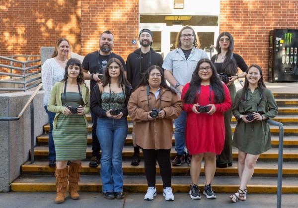 10 students from the Anthropological Film class standing together holding cameras in their hands