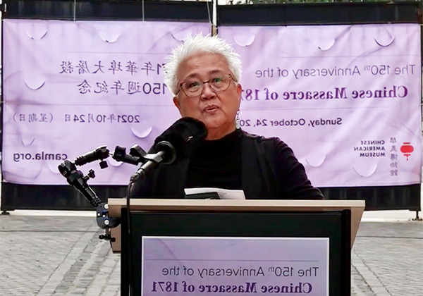 Gay Yuen speaking from a podium