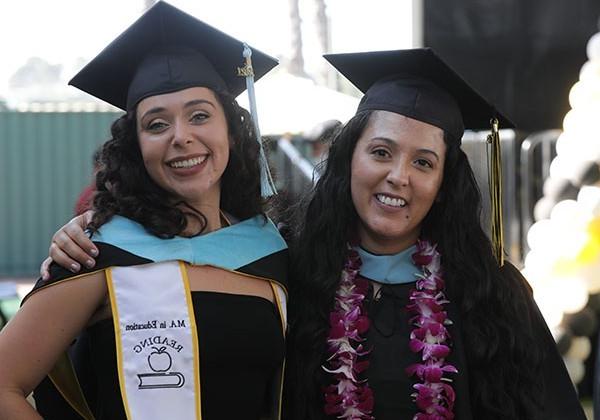 Two female graduates at commencement